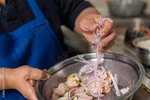 Cook mixing ingredients for a ceviche