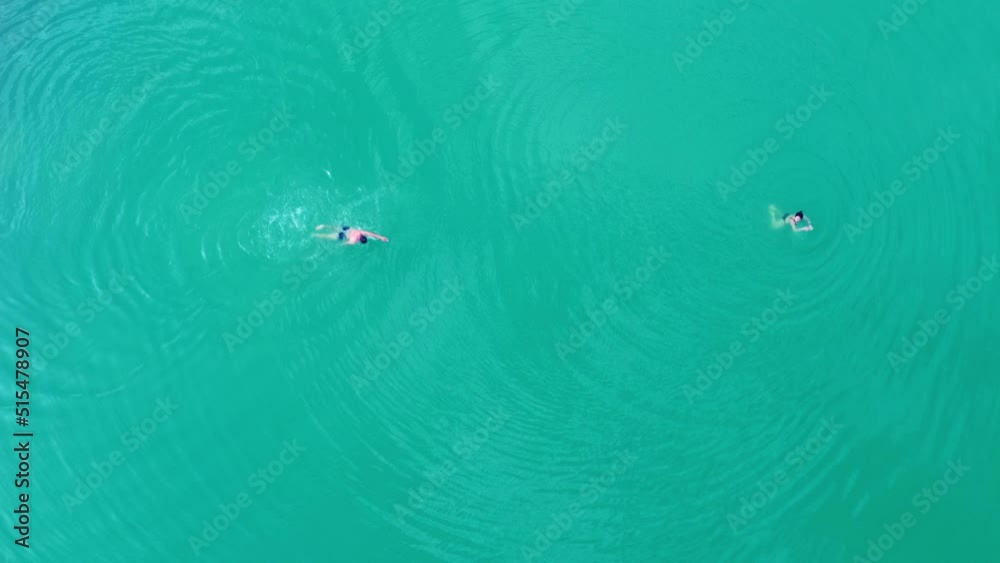 Aerial view. People swim in clear blue water. The concept of tourism and recreation. Aerial view. People swim in clear blue water. The concept of tourism and recreation.