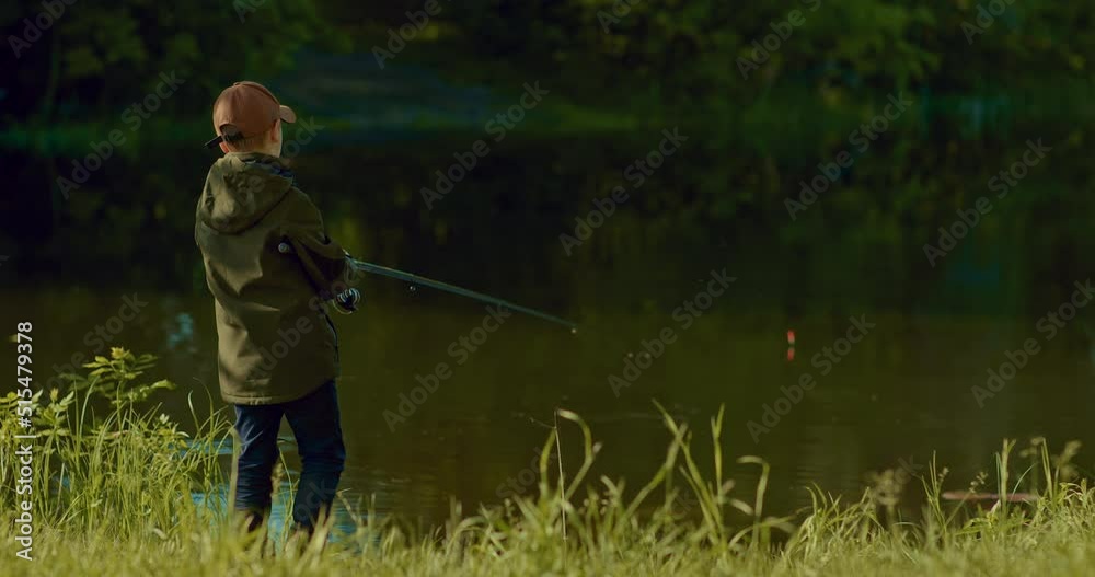 boy is fishing alone on small river shore, hooking and pulling little carp, 4K, Prores boy is fishing alone on small river shore, hooking and pulling little carp, 4K, Prores