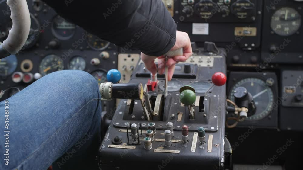 Pilot push thrust lever handle for takeoff a old plane in the cockpit and push back the lever. Pilot push thrust lever handle for takeoff a old plane in the cockpit and push back the lever.