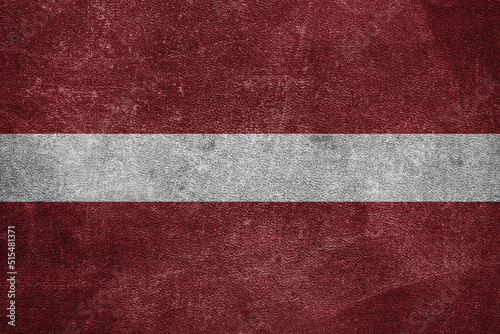 Old leather shabby background in colors of national flag. Latvia