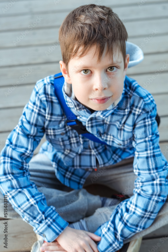 portrait of a teenager boy with big eyes in a blue plaid shirt. a boy with a serious look. teenager problems. portrait of a teenager boy with big eyes in a blue plaid shirt. a boy with a serious look. teenager problems.