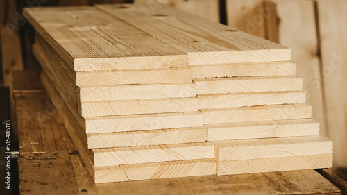 Stacked wooden carpentry boards from natural wood in a woodworking industry