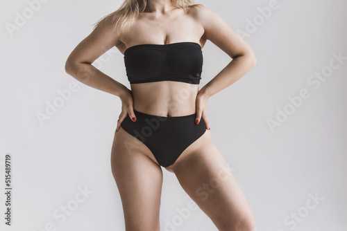 A plump blonde girl in a strapless bra is unrecognizable. The concept of body positivity and self acceptance photo