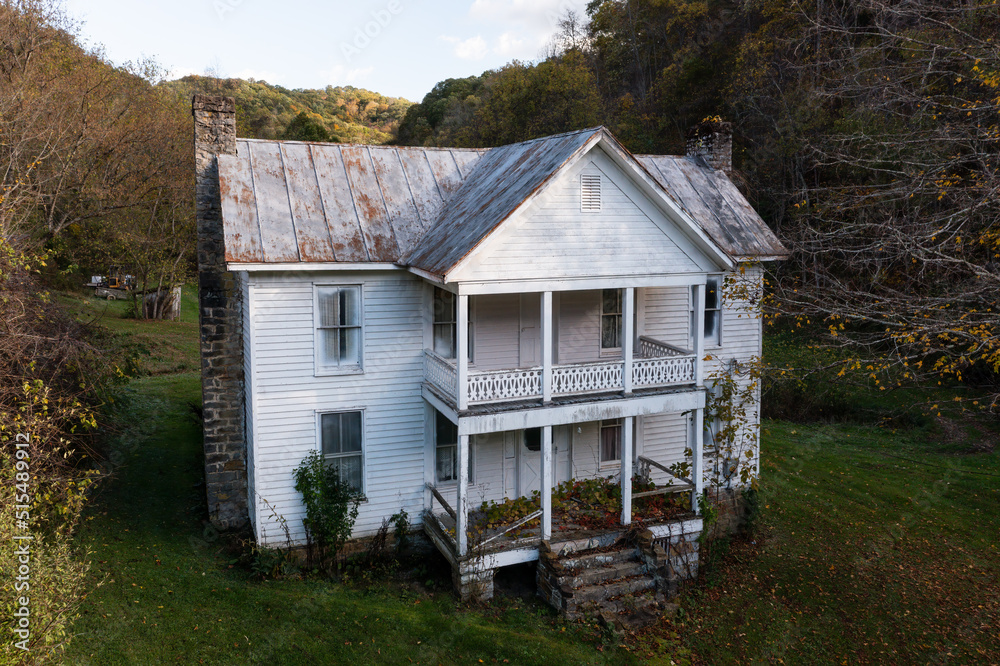 Aerial of Traditional Abandoned House with Large Front Porches - Appalachian Mountain Region - West Virginia Aerial of Traditional Abandoned House with Large Front Porches - Appalachian Mountain Region - West Virginia