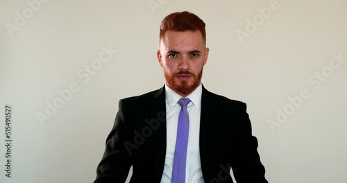 Redhead man wearing business suit changing mood, from happy to serious