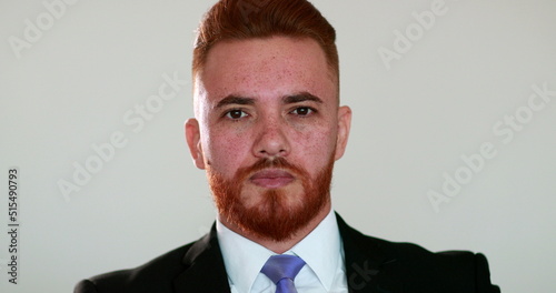 Obraz na plátne Portrait redhead man wearing business suit looking at camera, no emotion, photo