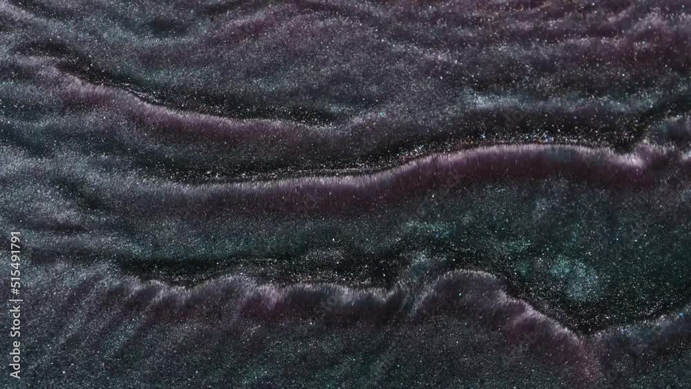 Abstract liquid grunge background, metallic sparkling purple turquoise water. High quality macro video of fluid art