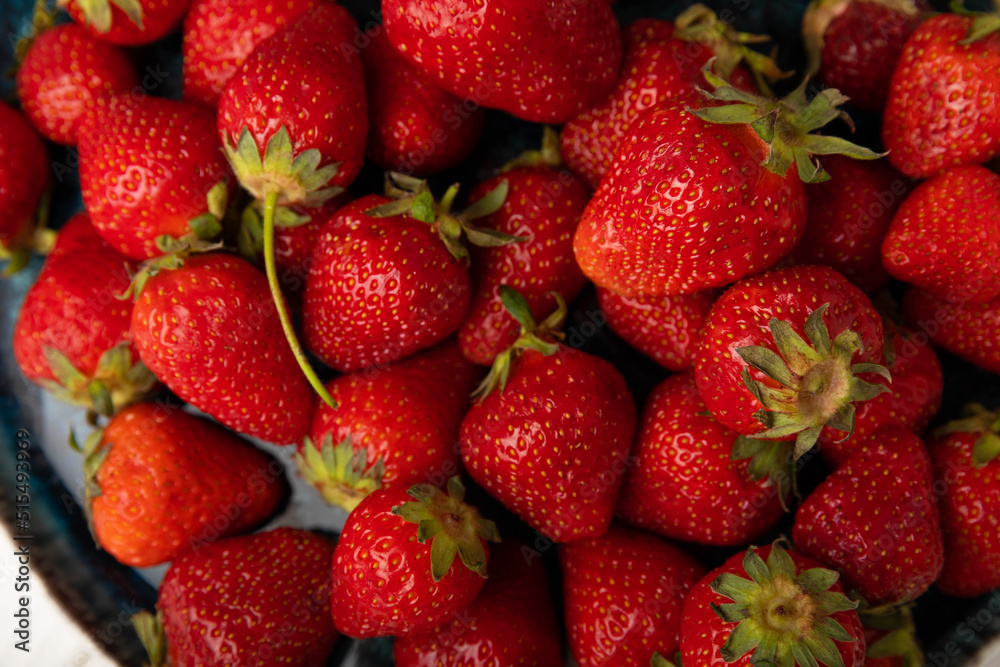 Fresh ripe strawberries in a plate on a white wooden background.Vegetarian organic berry.Healthy food.Vitamins.Copy space.Space for text Fresh ripe strawberries in a plate on a white wooden background.Vegetarian organic berry.Healthy food.Vitamins.Copy space.Space for text