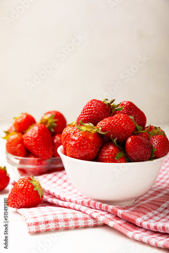 Fresh ripe strawberries in a plate on a white wooden background.Vegetarian organic berry.Healthy food.Vitamins.Copy space.Space for text
