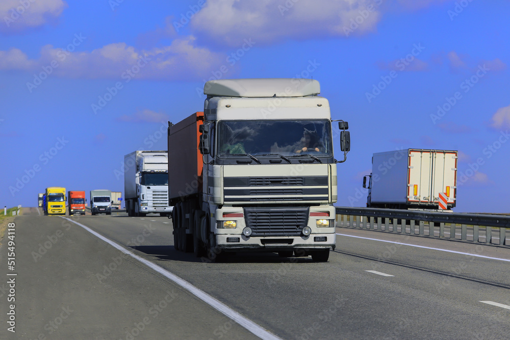 Trucks move along a suburban highway
