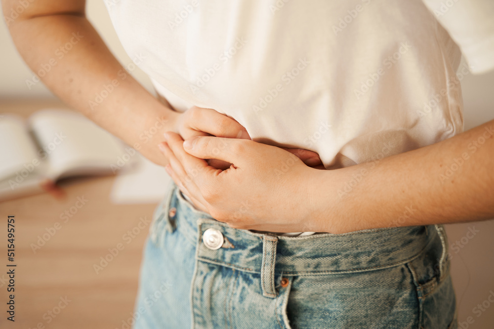 Stomach pain. Gastritis is an inflammation, irritation, or erosion of lining of stomach. Sick girl hold abdomen because it hurts. - obrazy, fototapety, plakaty 