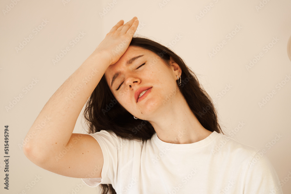 Migraine is a strong headache of woman. Overstressed woman touches her head because of pain. Depression of attractive girl. Migraine is a strong headache of woman. Overstressed woman touches her head because of pain. Depression of attractive girl.