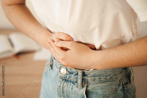 Stomach pain. Gastritis is an inflammation, irritation, or erosion of lining of stomach. Sick girl hold abdomen because it hurts.