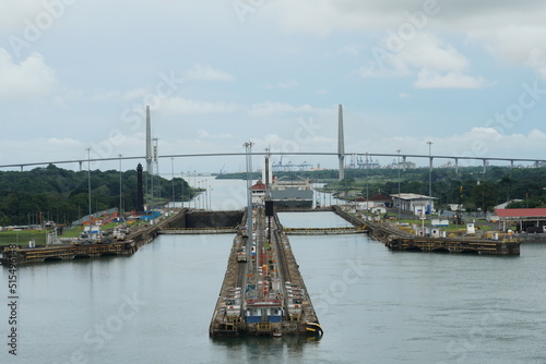 View on Gatun lock and bridge over the Panama Canal, known as the Atlantic Bridge from the ship passing to pacific side. In the horizon is blue sky and clouds with copy space. photo