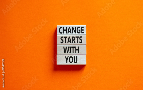 Change starts with you symbol. Concept words Change starts with you on wooden blocks on beautiful orange table orange background. Business motivational change starts with you concept