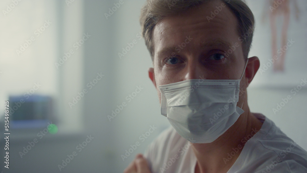 Man patient holding shoulder after vaccination sitting modern clinic close up. 