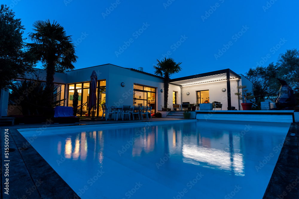 night shot of a modern house with pergola bioclimatic