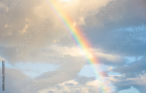 amazing bright rainbow in beautiful evening cloudy sky after rain and thunder, weather concept © Yaroslav
