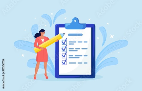 Woman is standing near large to do list and filling out checkbox. Plan fulfilled, task completed. Month planning, time management. Daily checklist