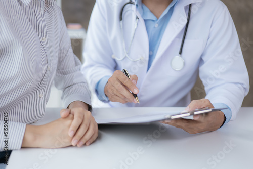 Close-up hands of doctor and patient in medical office.