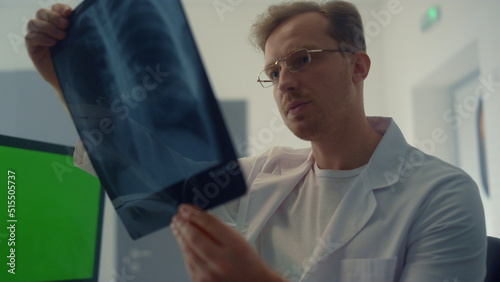 Physician checking x-ray lungs consulting using chroma key screen closeup.
