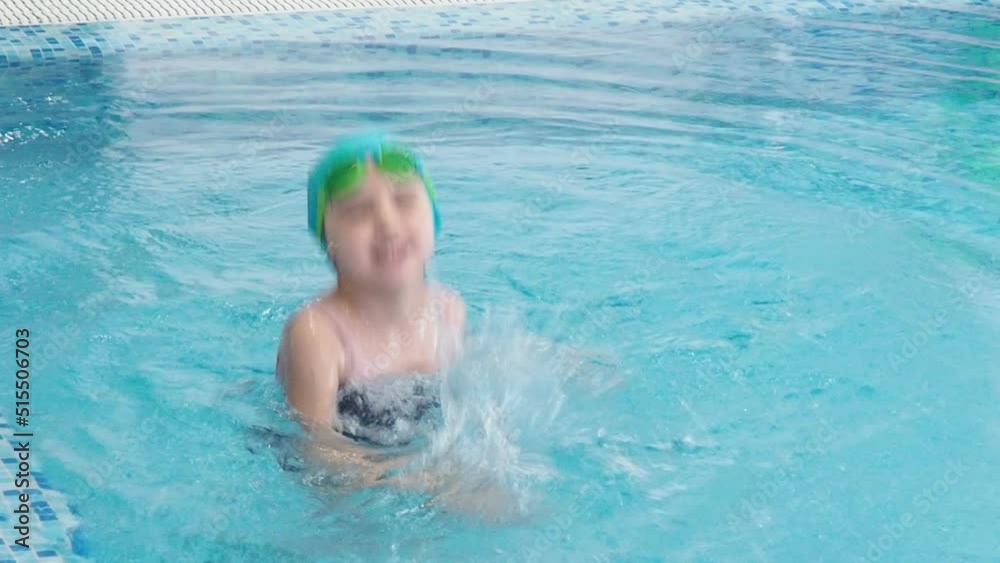 Little girl learning to swim with mother in big sport pool. Swimming school for small children. Healthy kid enjoying active lifestyle. Preschooler practicing with foam pad and noodle. Little girl learning to swim with mother in big sport pool. Swimming school for small children. Healthy kid enjoying active lifestyle. Preschooler practicing with foam pad and noodle.
