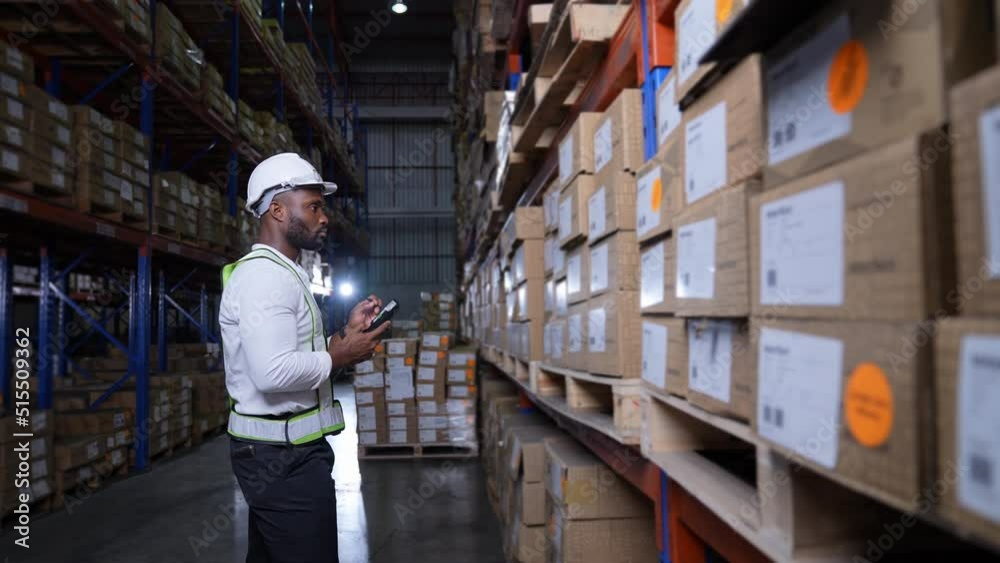 Business concept of 4k Resolution. African man checking goods in warehouse. Data collection of imported products from abroad. Business concept of 4k Resolution. African man checking goods in warehouse. Data collection of imported products from abroad.
