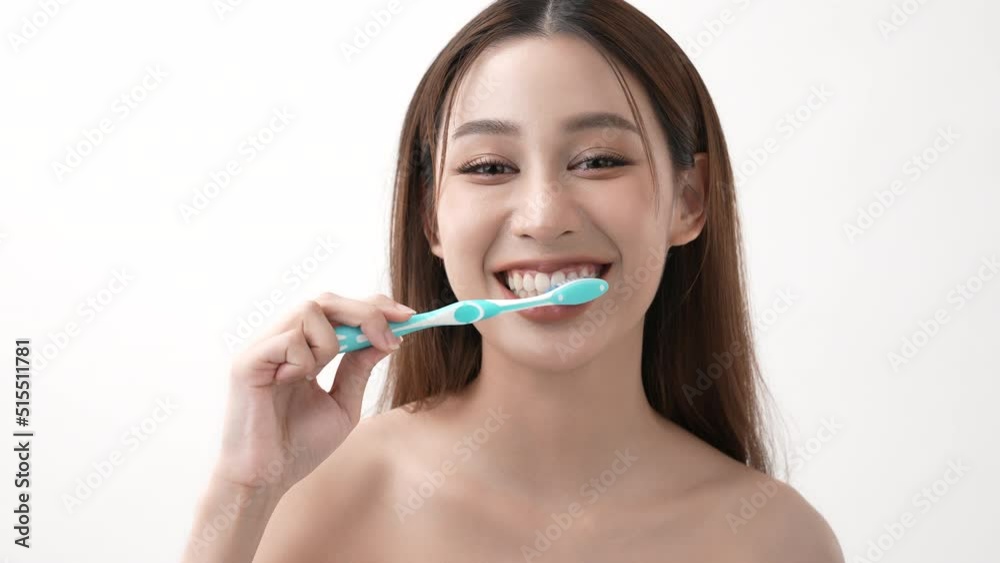 Beauty concept of 4k Resolution. Asian woman brushing teeth on a white background. Beauty concept of 4k Resolution. Asian woman brushing teeth on a white background.