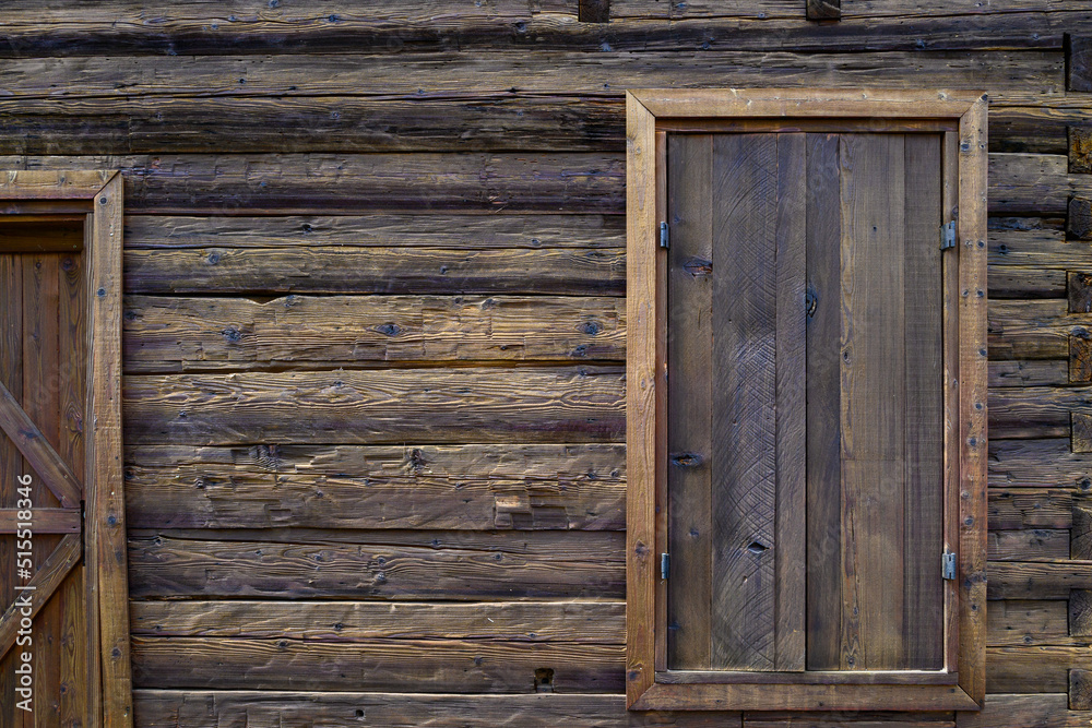 Wooden exterior of a rustic cabin built out of hand-hewn timber, as a textured background
Wooden exterior of a rustic cabin built out of hand-hewn timber, as a textured background