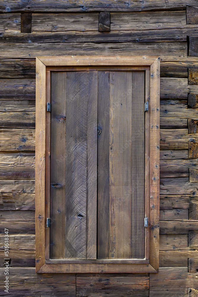 Wooden exterior of a rustic cabin built out of hand-hewn timber, as a textured background
Wooden exterior of a rustic cabin built out of hand-hewn timber, as a textured background