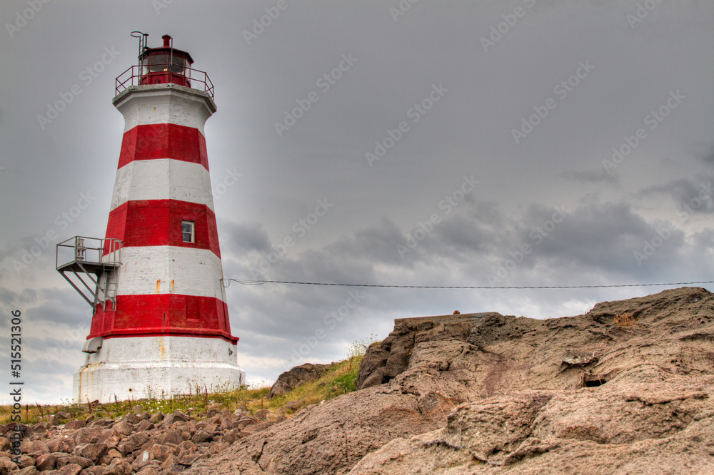 striped lighthouse with clouds