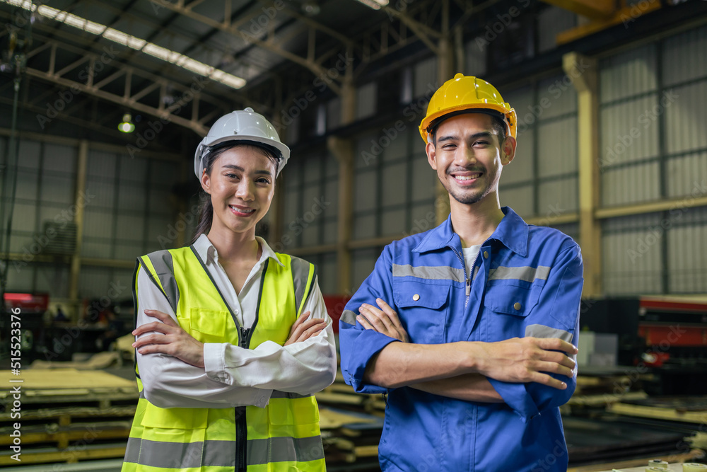 Portrait of Asian male and female industrial worker working in factory Portrait of Asian male and female industrial worker working in factory