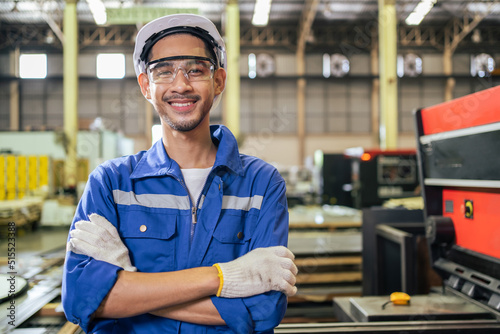 Fotografia, Obraz Portrait of Asian industrial worker man working in manufacturing plant