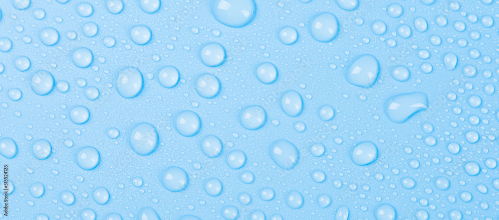 close up of water drops on blue background.
