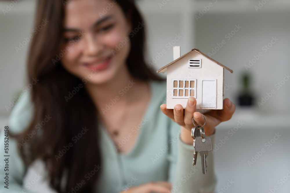 Close up Business woman or Real Estate agent giving house key after signing agreement for buying house. Bank manager and real estate concept. Close up Business woman or Real Estate agent giving house key after signing agreement for buying house. Bank manager and real estate concept.