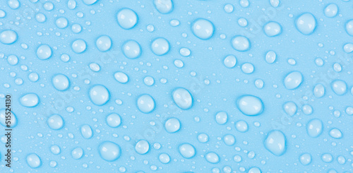 close up of water drops on blue background.