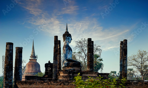 Beautiful scenic view of Wat Mahathat in Sukhothai historical park, Sukhothai, Thailand with sitting Buddha between ruins. UNESCO and World Heritage site. Travel concept.