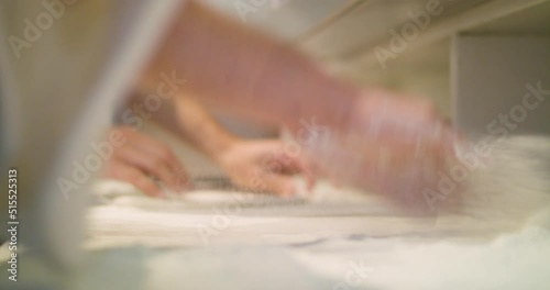 Kneading pizza dough in the kitchen - preparing pizzas