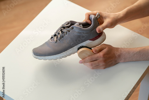 washing the sneakers with special brush tool, dirty shoes cleaning