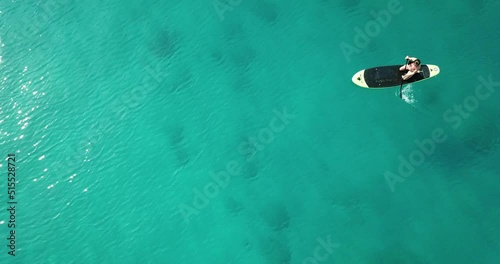 Woman on paddleboard.
Beautiful woman in bikini riding a paddleboard.