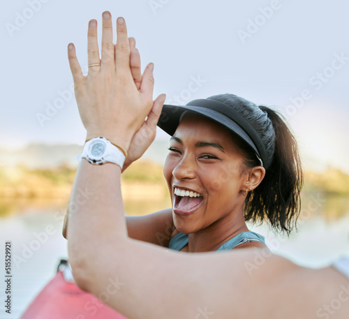 Canvas Print Two friends sharing high five and celebrating their success while being active outdoors