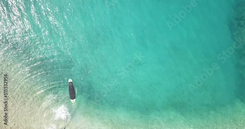 Woman on paddleboard.
Beautiful woman in bikini riding a paddleboard.