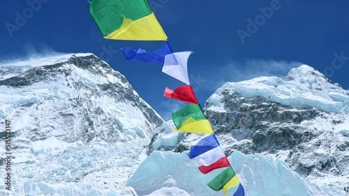 Spectacular landscape of snow capped Himalaya mountains with Nepali traditional colorful buddhist prayer flags fluttering in the wind near Everest base camp in Nepal