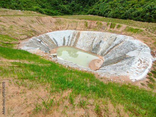 Permanent slope protection with grass using the hydroseed method. The grass is used to stabilize the slope structure and prevent slope erosion. Effective and less maintenance.  photo