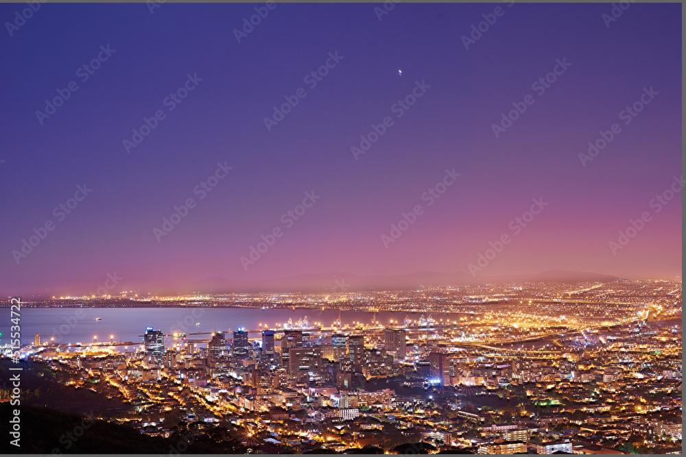 Copy space with twilight night sky over the view of a coastal city seen from Signal Hill in Cape Town South Africa. Scenic panoramic landscape of lights illuminating an urban skyline along the sea