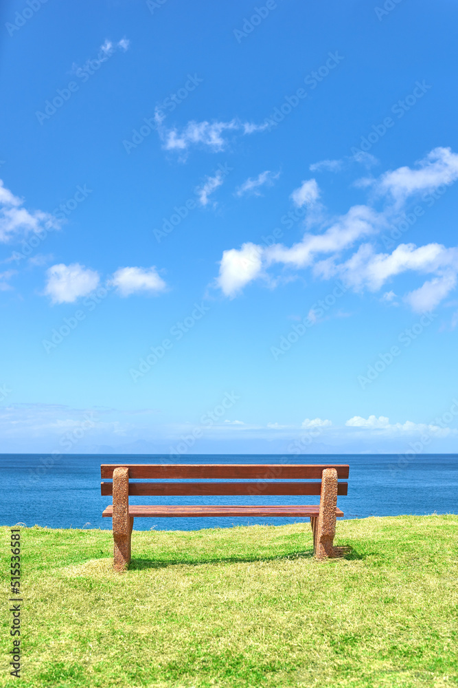 Beautiful beach view from a bench with copy space on a summer day with a blue sky background. Peaceful and calm seascape with a seat in a coastal vacation location. Scenic land of sea or ocean shore Beautiful beach view from a bench with copy space on a summer day with a blue sky background. Peaceful and calm seascape with a seat in a coastal vacation location. Scenic land of sea or ocean shore
