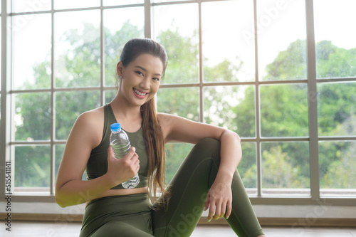 Young fitness woman in sportswear drinking water after exercising at home, Healthy and Lifestyles. Free Download Young fitness woman in sportswear drinking water after exercising at home, Healthy and Lifestyles. - GFXLoad
