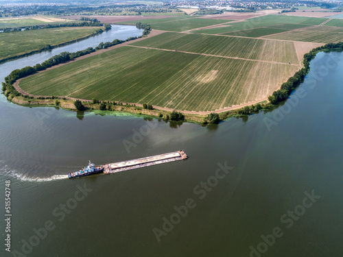 Fotobehang A cargo barge floats on a small river