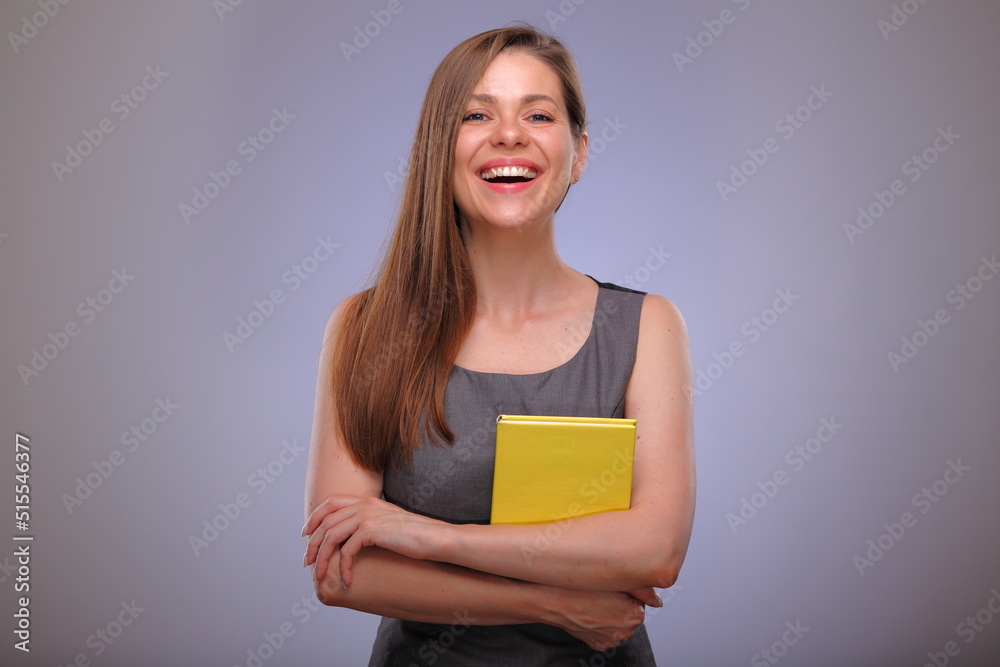 Woman teacher or adult student, smiling business person, Isolated female portrait with yellow book. Woman teacher or adult student, smiling business person, Isolated female portrait with yellow book.